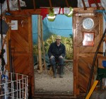Bob sitting outside rustic yurt workshop 2004